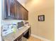 Home office features built-in desk and cabinets with granite countertop at 12031 Longview Lake Cir, Bradenton, FL 34211