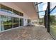 Relaxing screened patio with brick pavers and seating area at 12031 Longview Lake Cir, Bradenton, FL 34211