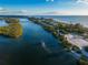Aerial view of a tranquil waterway with a boat passing by at 1215 E Venice Ave, Venice, FL 34285