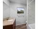 Clean bathroom with a tub and wood-look floors at 1215 E Venice Ave, Venice, FL 34285