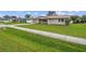 Single story house with a green lawn and sidewalk at 1215 E Venice Ave, Venice, FL 34285