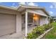 Front entrance with columns, bench, and landscaping at 1215 E Venice Ave, Venice, FL 34285