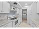 White kitchen cabinets, granite counters, and a view of the backyard at 1215 E Venice Ave, Venice, FL 34285