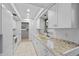 Modern kitchen featuring white cabinets, granite countertops and double sink at 1215 E Venice Ave, Venice, FL 34285