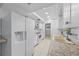 Updated kitchen with white cabinets, granite countertops, and new appliances at 1215 E Venice Ave, Venice, FL 34285