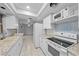 Updated kitchen with white cabinets and granite countertops at 1215 E Venice Ave, Venice, FL 34285
