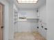 Laundry room with built-in shelving and window at 1215 E Venice Ave, Venice, FL 34285
