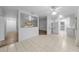 Open living area with tile floor and view into kitchen and hallway at 1215 E Venice Ave, Venice, FL 34285