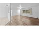 Open concept living room with wood-look floors and window at 1215 E Venice Ave, Venice, FL 34285