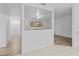 Living room with hardwood floors, open to hallway and kitchen at 1215 E Venice Ave, Venice, FL 34285
