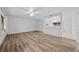 Spacious living room featuring light wood flooring and ceiling fan at 1215 E Venice Ave, Venice, FL 34285
