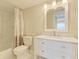 Updated bathroom with white vanity, quartz countertop and tiled shower at 129 Tyler Dr # 101, Sarasota, FL 34236