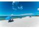 Relaxing beach scene with blue umbrellas and calm water at 129 Tyler Dr # 101, Sarasota, FL 34236