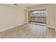 Bedroom with sliding glass doors leading to a private balcony at 129 Tyler Dr # 101, Sarasota, FL 34236