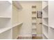 Spacious closet with built-in shelving and hanging rods at 129 Tyler Dr # 101, Sarasota, FL 34236