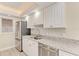 Updated kitchen with white cabinets, granite countertops, and stainless steel appliances at 129 Tyler Dr # 101, Sarasota, FL 34236