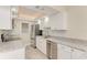 Updated kitchen with white cabinets, granite countertops and stainless steel appliances at 129 Tyler Dr # 101, Sarasota, FL 34236