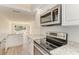 Modern kitchen with white cabinets and stainless steel appliances at 129 Tyler Dr # 101, Sarasota, FL 34236