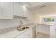 Updated kitchen with white cabinets, granite countertops, and stainless steel appliances at 129 Tyler Dr # 101, Sarasota, FL 34236