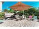 Enjoy outdoor dining on this patio featuring a table, chairs, umbrella, and grill at 129 Tyler Dr # 101, Sarasota, FL 34236