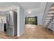 Stainless steel refrigerator in kitchen with wood-look flooring at 129 Woodland Pl, Osprey, FL 34229