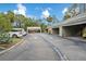 View of condo complex parking area with garages at 129 Woodland Pl, Osprey, FL 34229