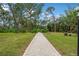 Landscaped pathway with stone border and bench at 129 Woodland Pl, Osprey, FL 34229