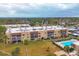 Aerial view of condo building, pool, and surrounding area at 1330 Glen Oaks E Dr # 268D, Sarasota, FL 34232