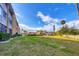 Landscaped backyard with grassy area and building view at 1330 Glen Oaks E Dr # 268D, Sarasota, FL 34232