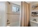 Updated bathroom with a shower/tub combo and neutral tile at 1330 Glen Oaks E Dr # 268D, Sarasota, FL 34232