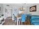 Elegant dining area with glass top table and blue chairs at 1330 Glen Oaks E Dr # 268D, Sarasota, FL 34232