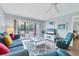 Living room with comfy seating, balcony access and TV at 1330 Glen Oaks E Dr # 268D, Sarasota, FL 34232
