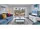 Living room with comfy seating, balcony access and TV at 1330 Glen Oaks E Dr # 268D, Sarasota, FL 34232