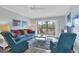 Living room with comfy seating, balcony access and TV at 1330 Glen Oaks E Dr # 268D, Sarasota, FL 34232
