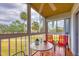 Screened porch with seating area and tranquil view at 1330 Glen Oaks E Dr # 268D, Sarasota, FL 34232