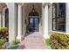 Elegant home exterior featuring a grand entrance with columns and double doors at 13605 Legends Walk Ter, Lakewood Ranch, FL 34202