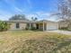Charming single-story home with a well-maintained lawn, a screened porch and an attached two car garage at 1382 Ronald St, North Port, FL 34286
