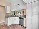 Kitchen featuring stainless steel dishwasher, granite countertops, and white cabinets at 1382 Ronald St, North Port, FL 34286