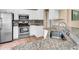Modern kitchen with stainless steel appliances, granite countertops, and white cabinets at 1382 Ronald St, North Port, FL 34286