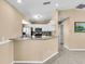 Open concept kitchen featuring stainless steel appliances, granite countertops, and breakfast bar at 1382 Ronald St, North Port, FL 34286