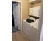 Functional laundry room equipped with appliances and storage cabinets at 1382 Ronald St, North Port, FL 34286
