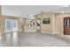 Spacious living room with tile flooring, leading to backyard access and an open kitchen at 1382 Ronald St, North Port, FL 34286