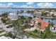 Waterfront home with red tile roof and lush landscaping at 1389 Tangier Way, Sarasota, FL 34239