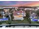 Waterfront property showcasing a large pool and beautiful sunset at 1389 Tangier Way, Sarasota, FL 34239
