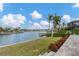 Steps lead down to a beautiful pool and patio overlooking the water at 1389 Tangier Way, Sarasota, FL 34239
