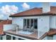 Relaxing balcony with patio furniture and water views at 1389 Tangier Way, Sarasota, FL 34239