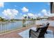 Relaxing balcony overlooking the water with outdoor seating at 1389 Tangier Way, Sarasota, FL 34239