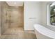 Spa-like bathroom with a large walk-in shower and a freestanding soaking tub at 1389 Tangier Way, Sarasota, FL 34239