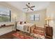 Bright bedroom with hardwood floors, a ceiling fan and a cozy rug at 1389 Tangier Way, Sarasota, FL 34239