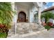 Elegant entryway with arched double doors and stone steps at 1389 Tangier Way, Sarasota, FL 34239